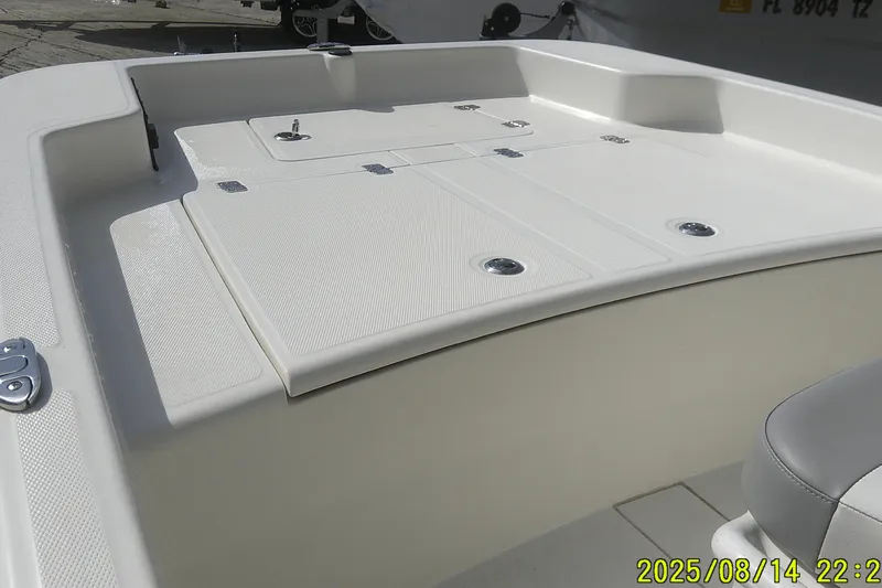 Slide: The Image of 2024 Mako Pro Skiff 15 CC boat deck with storage compartments and seating. - 7