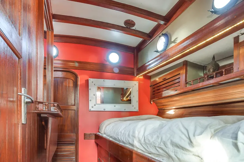 Slide: The Image of 1971 Formosa 41 yacht interior with wooden accents and cozy sleeping area. - 12