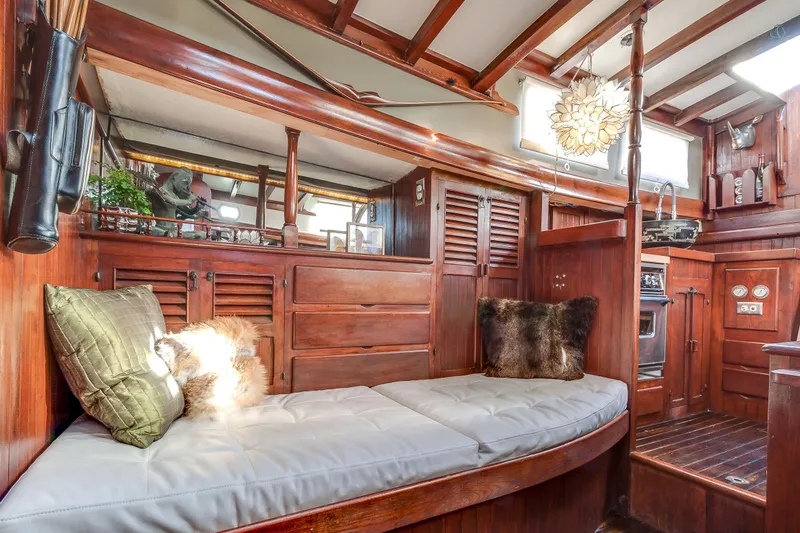 Slide: The Image of Interior of a 1971 Formosa 41 sailboat with wooden furnishings and cozy seating. - 13