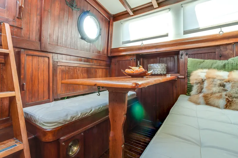 Slide: The Image of Cozy interior of 1971 Formosa 41 sailboat with wooden furnishings and plush seating. - 15