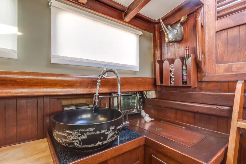 Slide: The Image of Vintage 1971 Formosa 41 yacht interior with wooden cabinetry and decorative sink. - 17