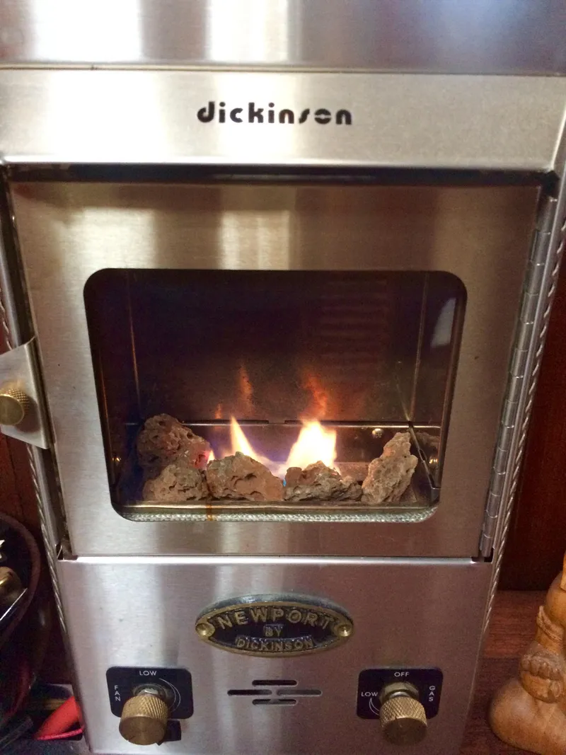 Slide: The Image of Dickinson Newport stove with visible flames, installed on a 1971 Formosa 41 boat. - 18