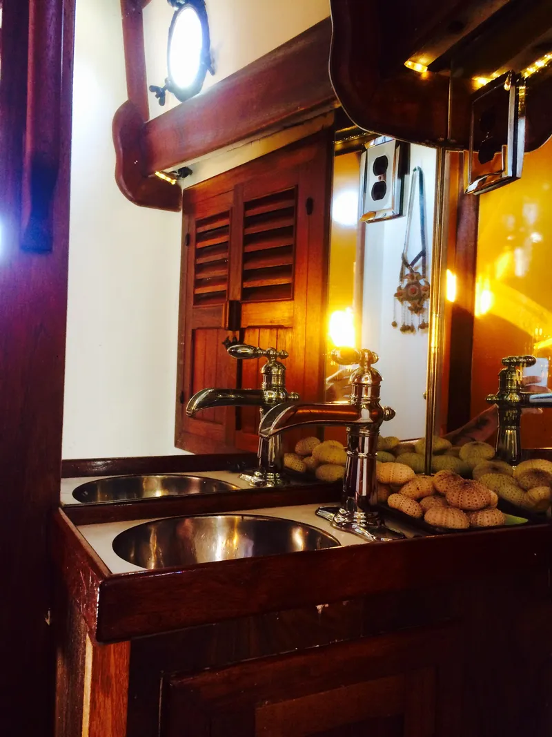 Slide: The Image of Vintage 1971 Formosa 41 yacht interior with wooden cabinetry and dual sinks. - 20