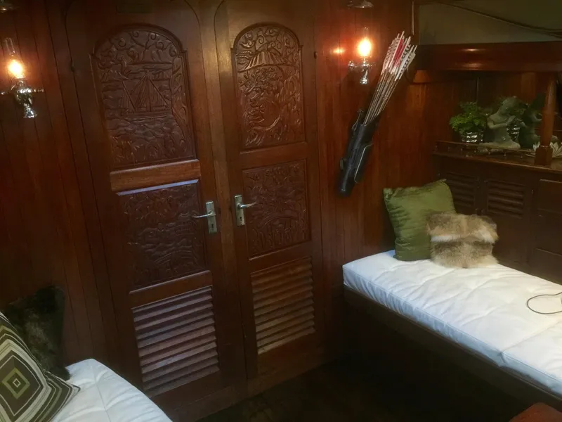 Slide: The Image of Interior of 1971 Formosa 41 yacht with carved wooden doors and cozy seating area. - 28