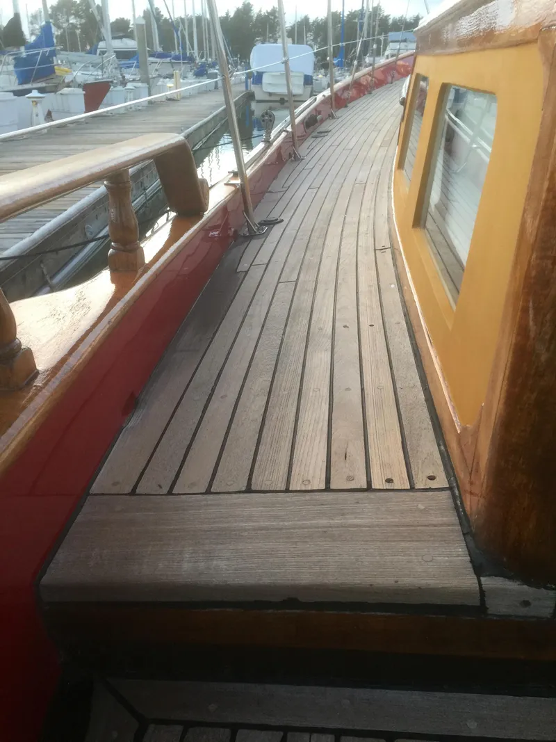 Slide: The Image of 1971 Formosa 41 sailboat deck with wooden finish and vibrant cabin colors. - 33