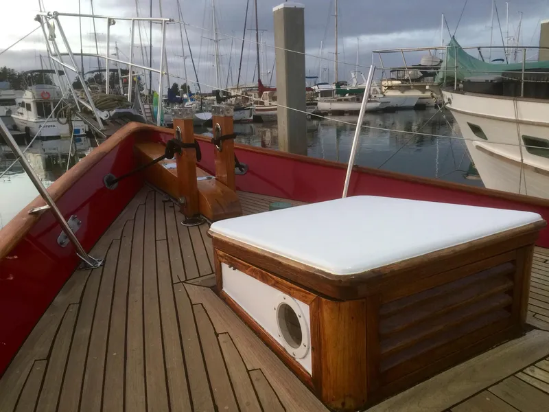 Slide: The Image of 1971 Formosa 41 sailboat deck with wooden details, docked in a marina. - 35