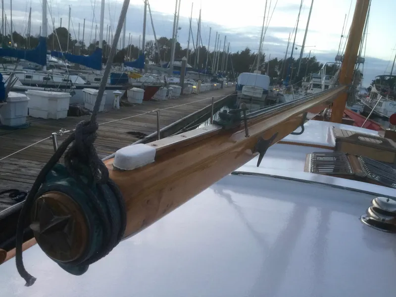 Slide: The Image of 1971 Formosa 41 sailboat deck with wooden boom, docked in marina. - 38