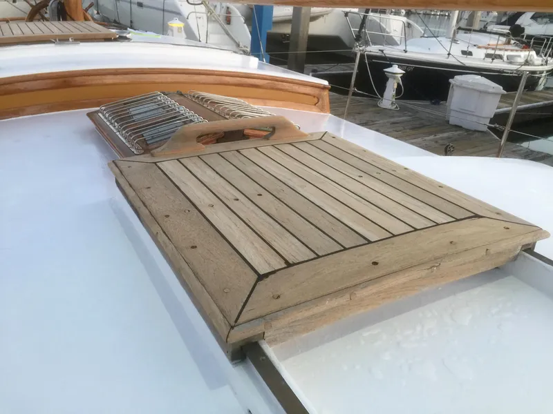 Slide: The Image of Wooden deck hatch on a 1971 Formosa 41 sailboat, docked at a marina. - 43