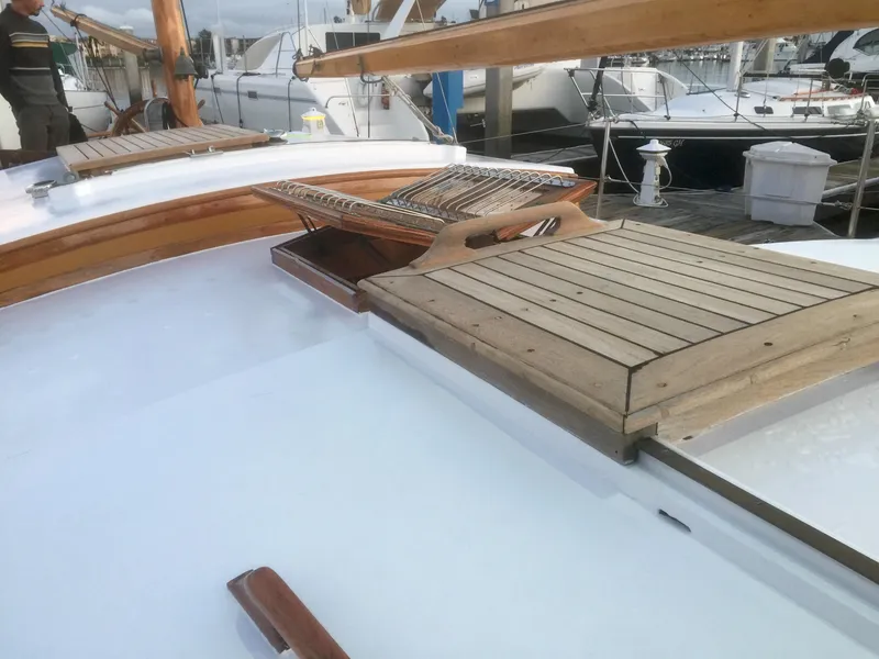 Slide: The Image of 1971 Formosa 41 sailboat deck with wooden hatch and seating area. - 44