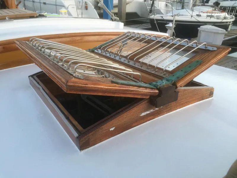 Slide: The Image of Wooden hatch on 1971 Formosa 41 sailboat, open with metal grill, docked in marina. - 45