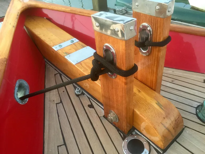 Slide: The Image of Wooden deck details of a 1971 Formosa 41 sailboat with red accents and metal fittings. - 49