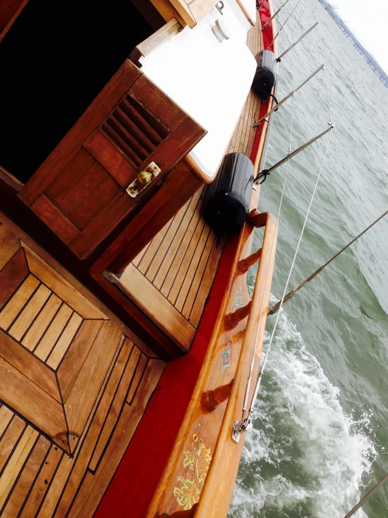 Slide: The Image of 1971 Formosa 41 sailboat with wooden deck, sailing on open water. - 6