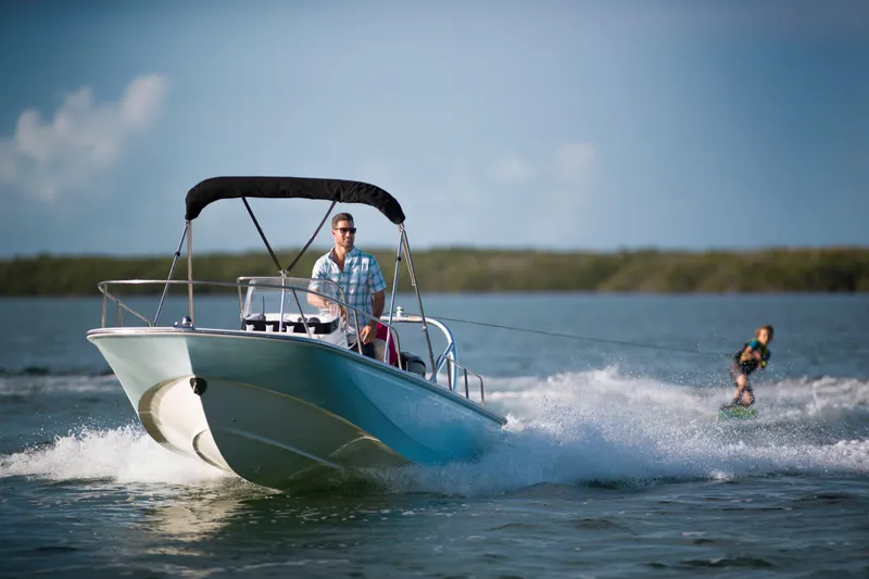 The Image of 2026 Boston Whaler 170 Montauk boat on trailer, dockside, under clear blue sky. - 0