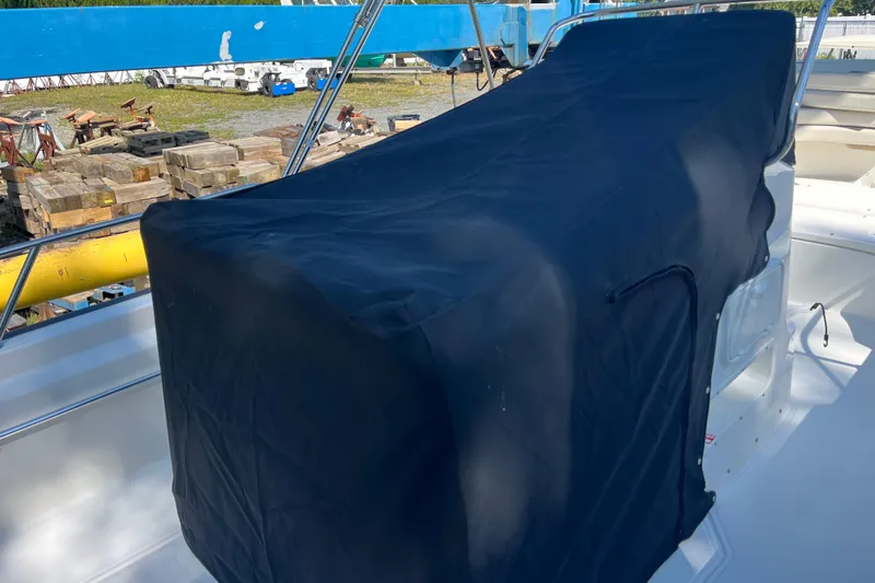 Slide: The Image of Covered 2026 Boston Whaler 170 Montauk boat, docked with protective cover. - 18