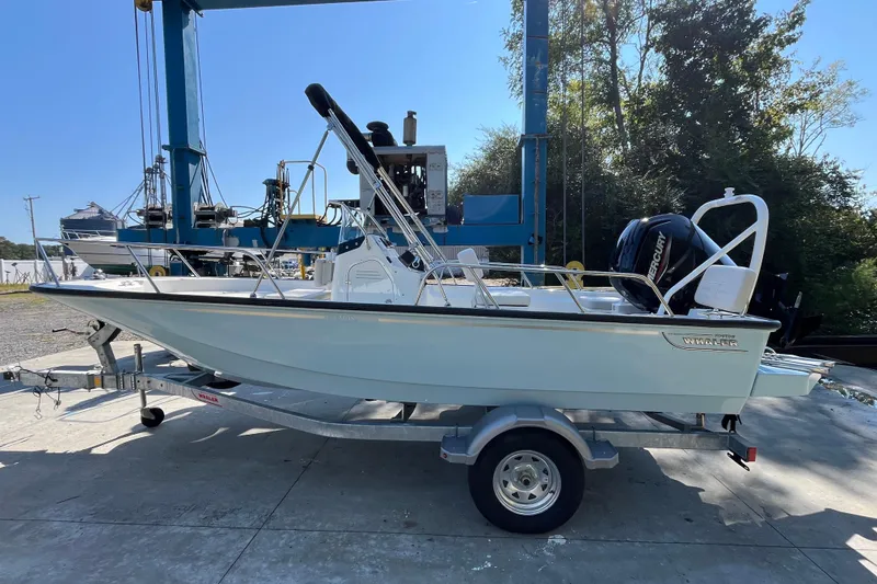 Slide: The Image of 2026 Boston Whaler 170 Montauk boat on trailer, outdoor setting, sunny day. - 19