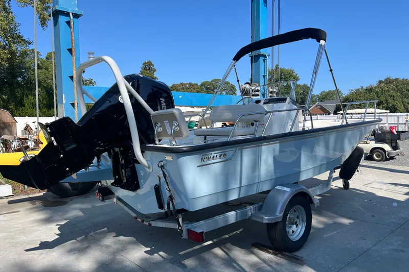 Slide: The Image of 2026 Boston Whaler 170 Montauk boat on trailer, outdoor setting, clear blue sky. - 21