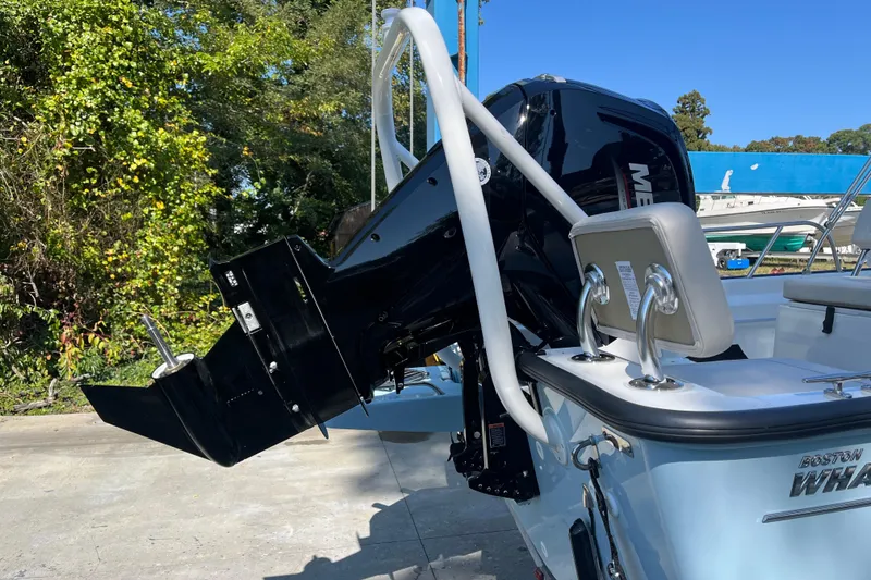 Slide: The Image of 2026 Boston Whaler 170 Montauk boat with Mercury outboard motor, docked outdoors. - 22