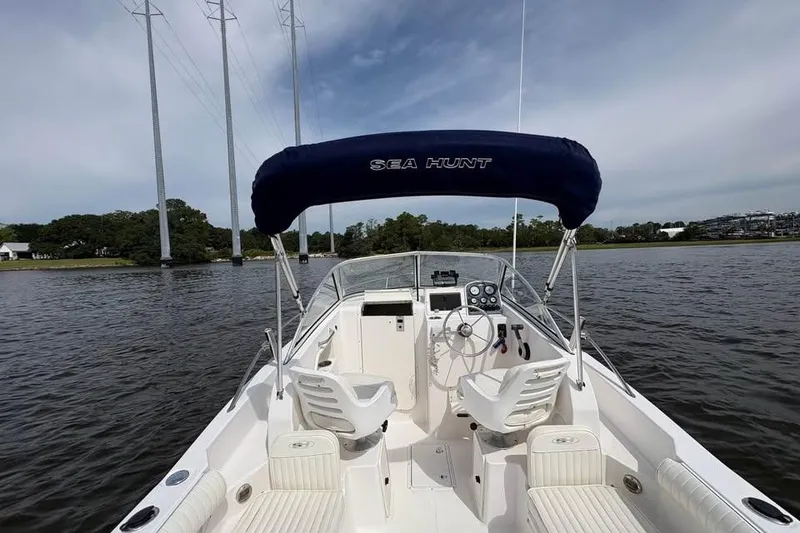 Slide: The Image of 2007 Seahunt VICTORY 225 boat on calm water, featuring a canopy and dual seating. - 11