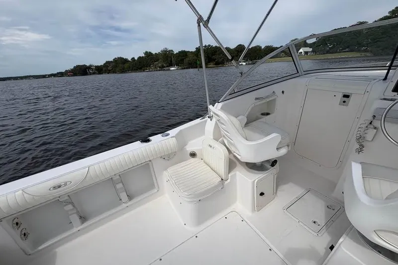Slide: The Image of 2007 Seahunt VICTORY 225 boat interior with seating, on calm water, under cloudy sky. - 13