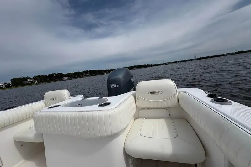 Slide: The Image of 2007 Seahunt VICTORY 225 boat interior with Yamaha 150 engine on a calm lake. - 17