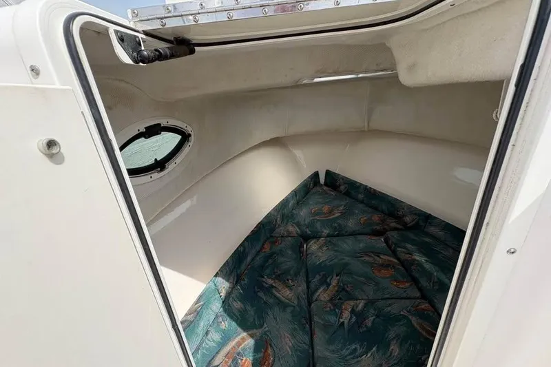Slide: The Image of 2007 Seahunt VICTORY 225 cabin interior with patterned cushions and porthole window. - 18