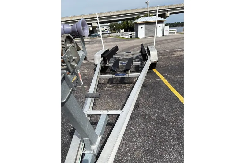Slide: The Image of Boat trailer for 2007 Seahunt VICTORY 225, parked in a lot near a bridge. - 5