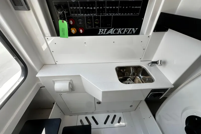 Slide: The Image of 2025 Blackfin 332 CC boat interior with control panel and compact sink. - 14