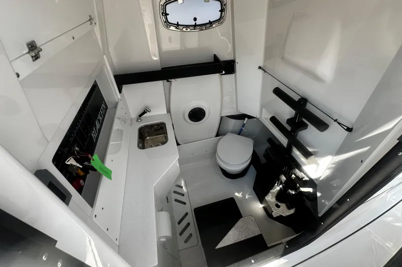 Slide: The Image of 2025 Blackfin 332 CC boat interior with sink, toilet, and storage area. - 15