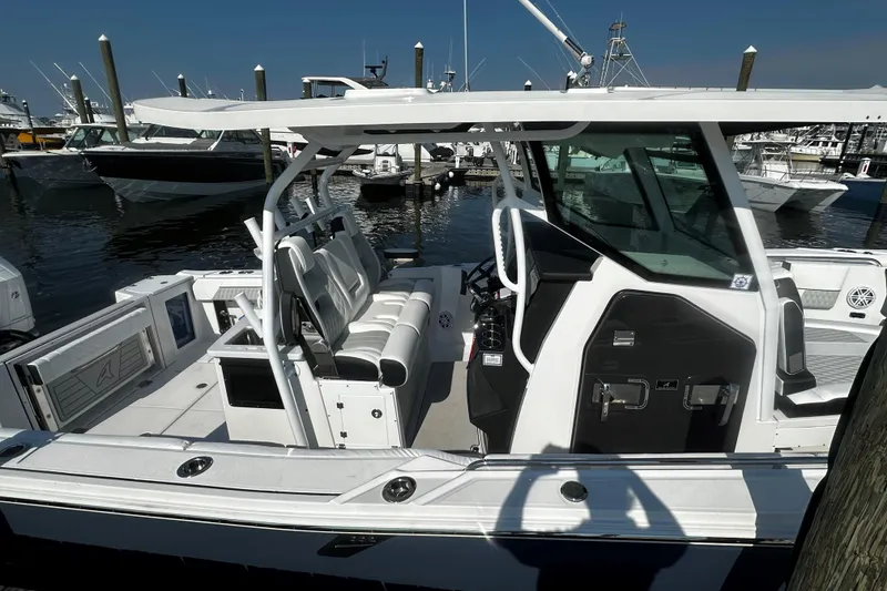 Slide: The Image of 2025 Blackfin 332 CC boat docked at marina, showcasing sleek design and spacious seating. - 3