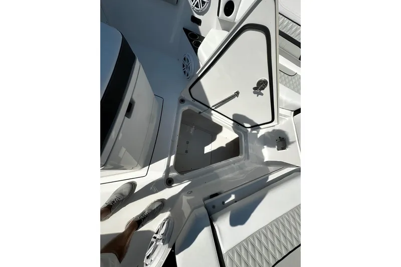 Slide: The Image of 2025 Blackfin 332 CC boat interior with open storage compartment and speaker. - 9