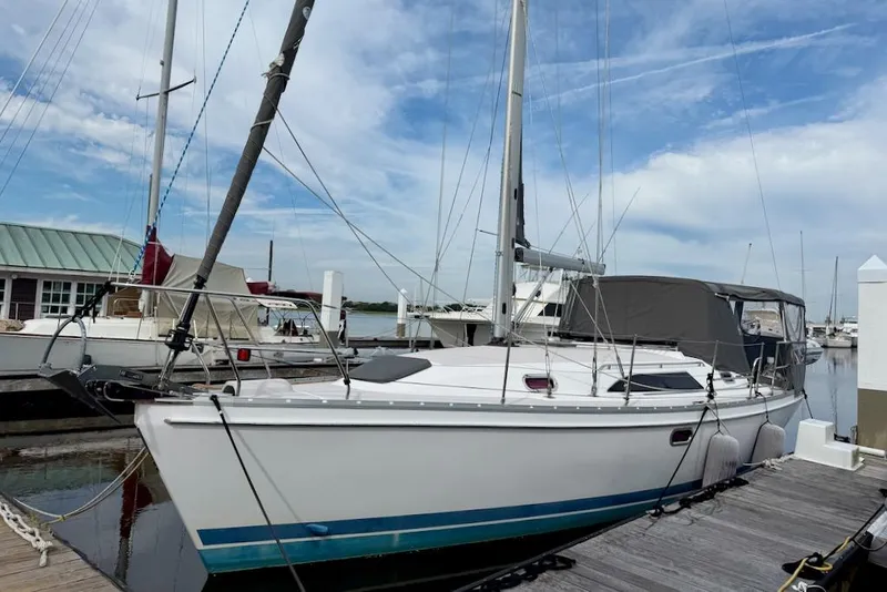 Slide: The Image of 2011 Catalina 355 sailboat docked at marina under clear blue sky. - 1