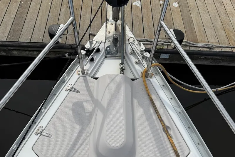 Slide: The Image of Bow of a 2011 Catalina 355 sailboat docked at a wooden pier. - 18