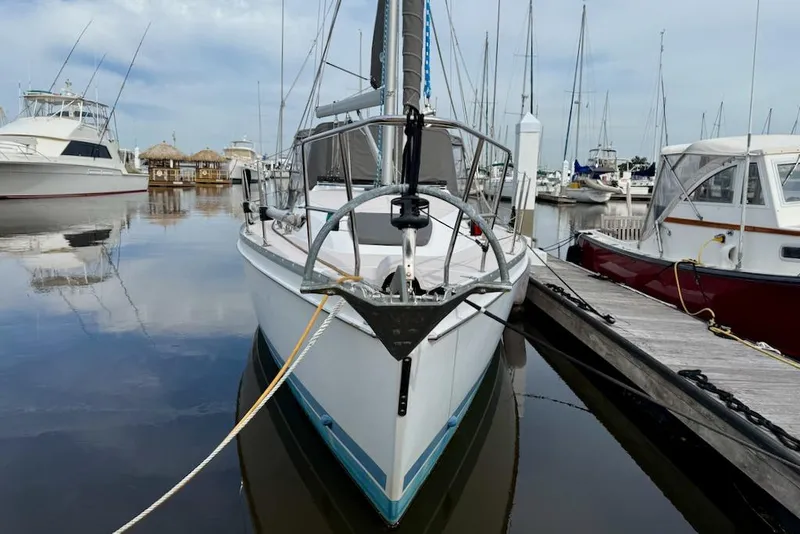 Slide: The Image of Catalina 355 sailboat from 2011 docked at a marina, surrounded by other boats. - 2