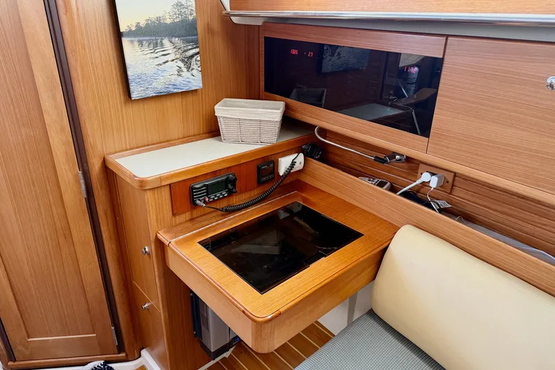 Slide: The Image of 2011 Catalina 355 yacht interior with navigation station and wooden cabinetry. - 27