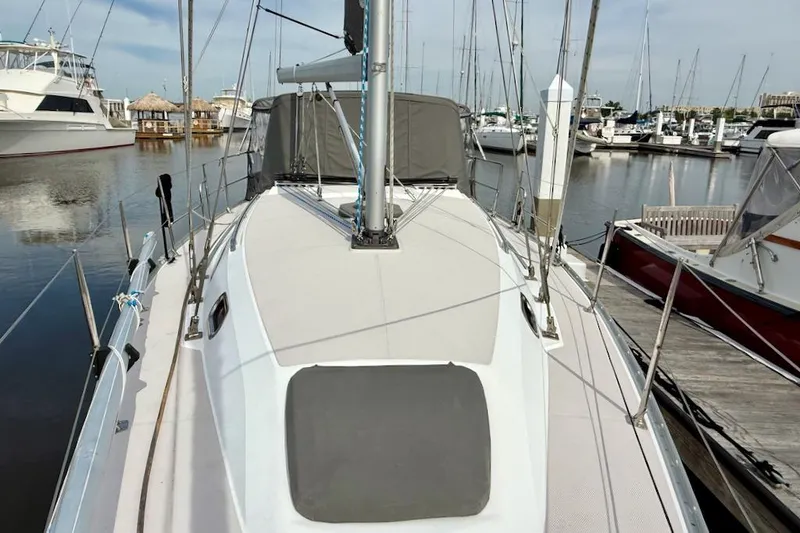 Slide: The Image of 2011 Catalina 355 sailboat docked at marina, showcasing deck and rigging. - 3