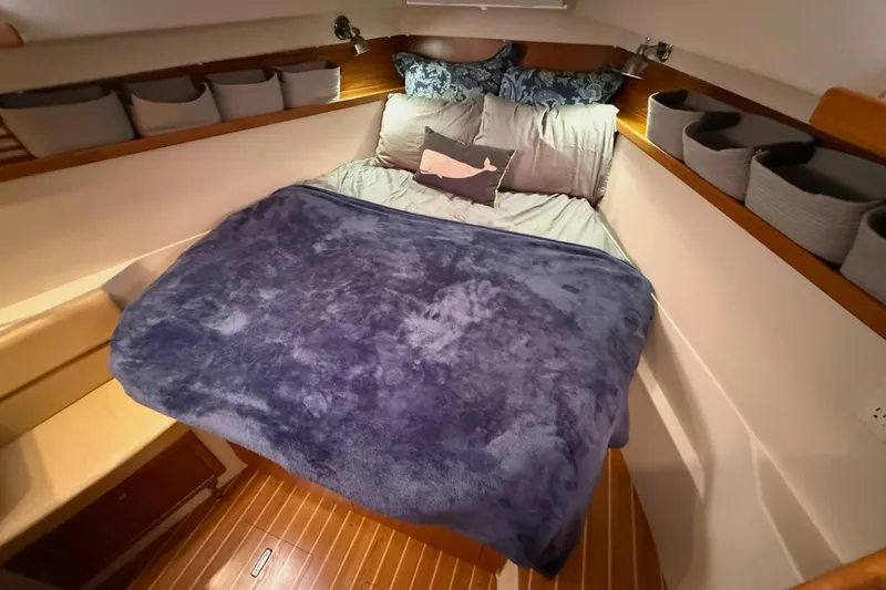 Slide: The Image of Cozy cabin interior of 2011 Catalina 355 sailboat with plush bedding and organized storage. - 33