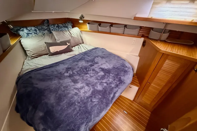 Slide: The Image of Cozy cabin interior of 2011 Catalina 355 sailboat with plush bedding and wooden accents. - 34