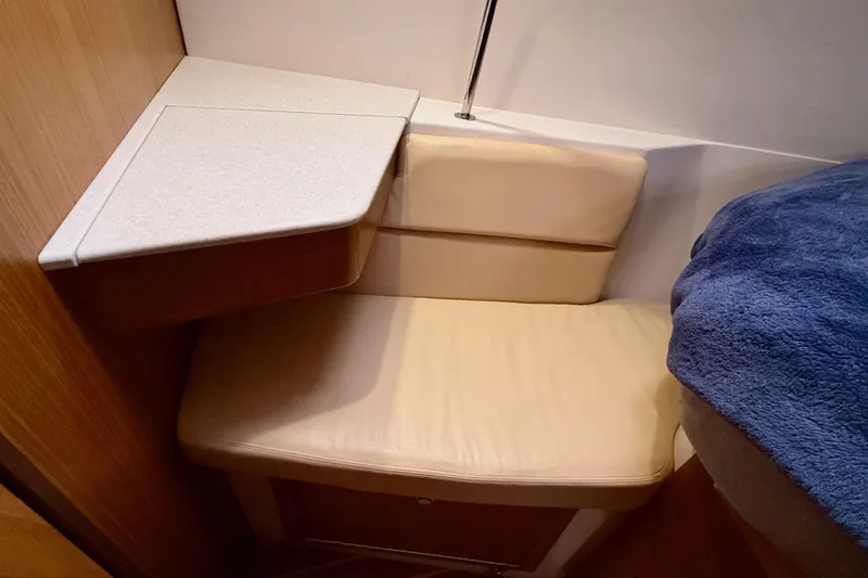 Slide: The Image of Cozy seating area in 2011 Catalina 355 sailboat cabin with cushioned bench and table. - 35