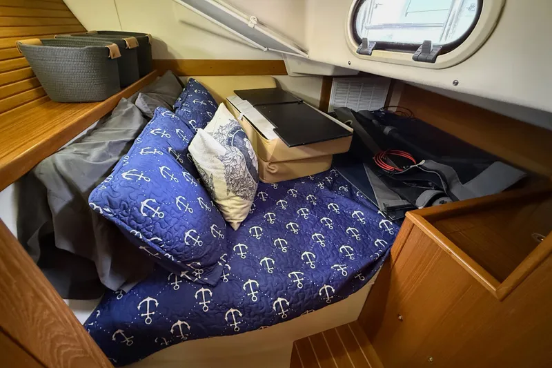 Slide: The Image of Cozy cabin interior of 2011 Catalina 355 sailboat with nautical-themed bedding. - 36