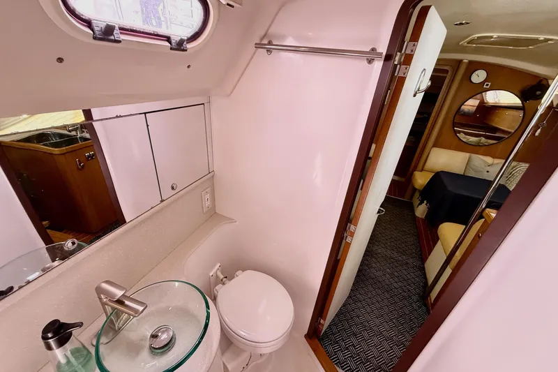 Slide: The Image of Interior of 2011 Catalina 355 yacht featuring bathroom and cozy cabin area. - 37