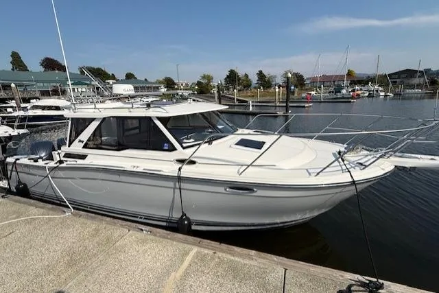 The Image of 2024 Cutwater C-288 Coupe docked at a marina, showcasing sleek design and modern features. - 0