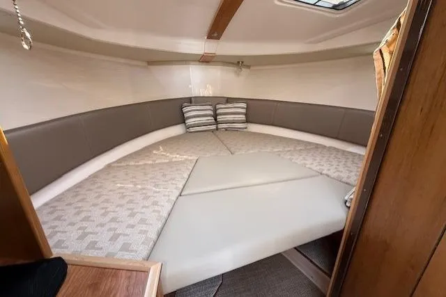 Slide: The Image of 2024 Cutwater C-288 Coupe interior cabin with cozy bedding and cushions. - 11