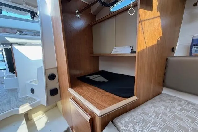 Slide: The Image of 2024 Cutwater C-288 Coupe interior with wooden cabinetry and seating area. - 12