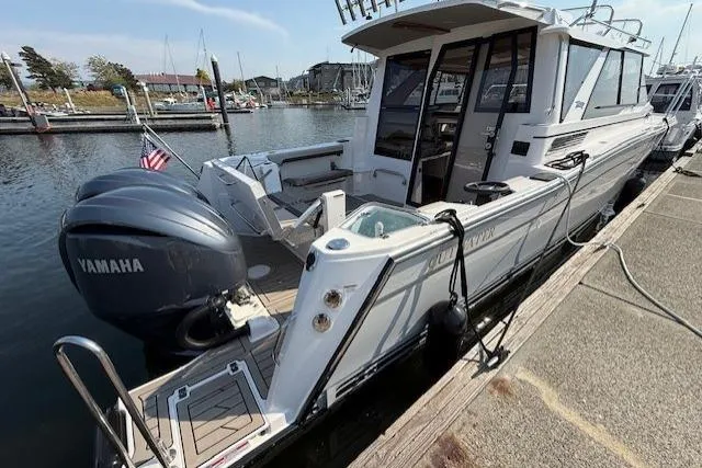 Slide: The Image of 2024 Cutwater C-288 Coupe boat docked with Yamaha engines, rear view. - 4