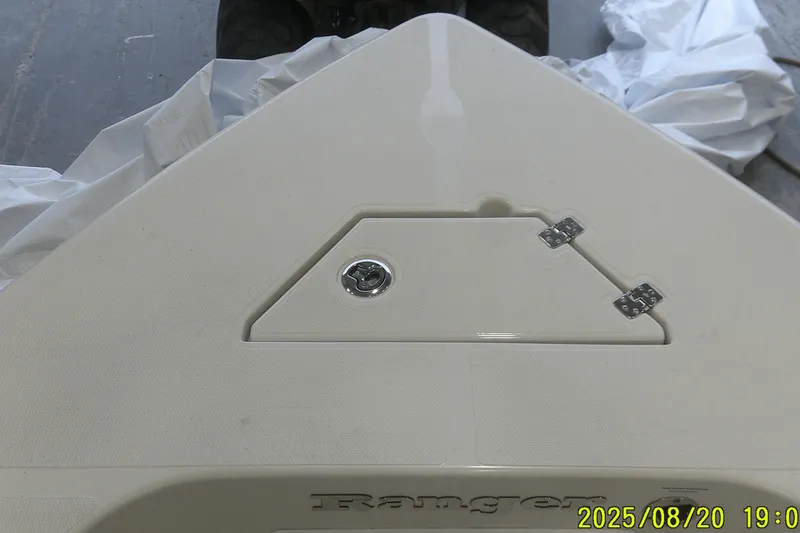 Slide: The Image of 2024 Ranger 2600 Bay boat deck with storage compartment and hinges. - 10
