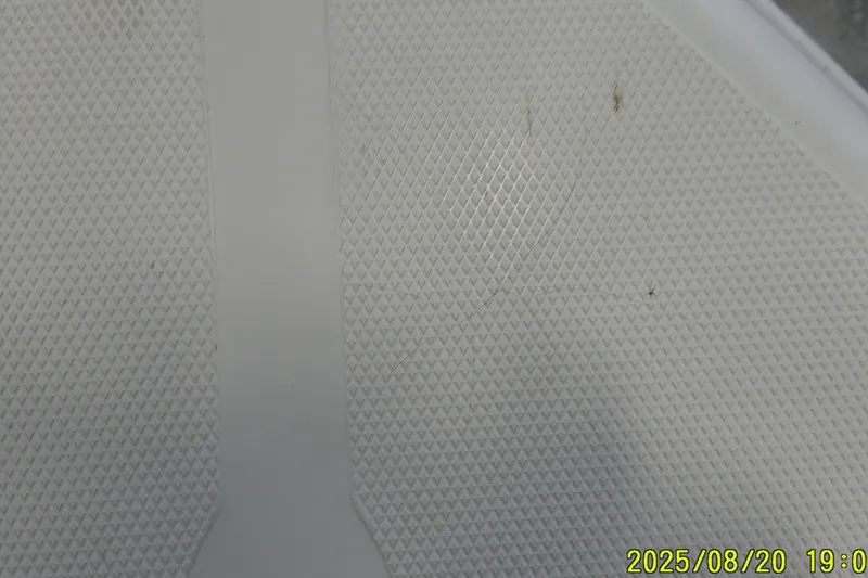 Slide: The Image of Textured surface of a 2024 Ranger 2600 Bay boat, close-up view. - 11