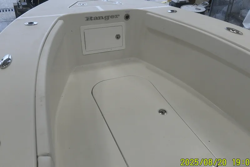 Slide: The Image of 2024 Ranger 2600 Bay boat interior with storage compartment, beige finish. - 13
