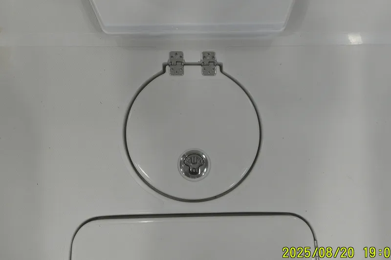 Slide: The Image of 2024 Ranger 2600 Bay boat hatch with circular design and metal latch. - 17