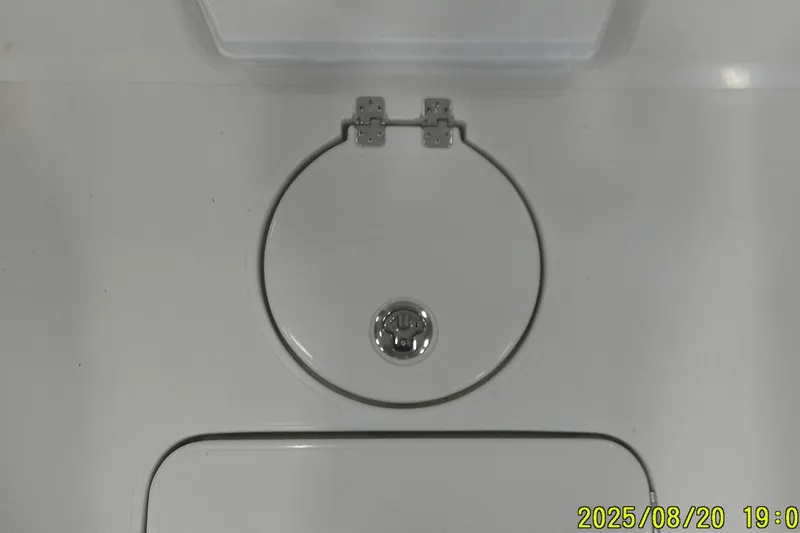 Slide: The Image of 2024 Ranger 2600 Bay boat hatch with circular design and metal hinges. - 18