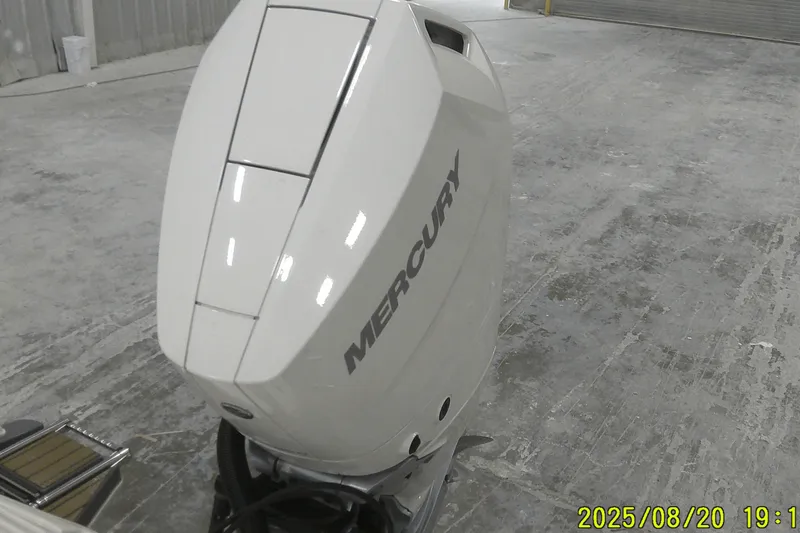 Slide: The Image of 2024 Ranger 2600 Bay with Mercury outboard engine in a garage setting. - 2
